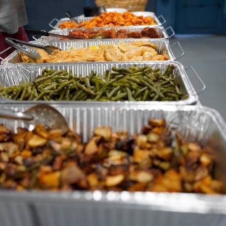 Roasted chicken and greens plated for a catered meal